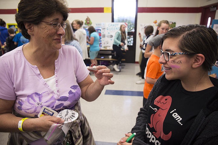 &lt;p&gt;LOREN BENOIT/Press Penny Wright, left, savors the flavor of a Troll Chocolate Bite, made by Candy Stuck owner Adrianna Preciado, right, on Wednesday, April 27, 2016 at the Canfield Middle School Candy Expo. Students in their language arts classes had to create a company, a featured product, a logo, advertising strategies and packaging for the Expo.&lt;/p&gt;