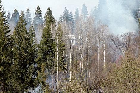 &#151;Photo by KATHY NUSSBERGER&lt;br&gt;Late Monday afternoon multiple slash piles began burning out-of-control, resulting in the evacuation of two homes that were in immediate danger on Hooten Hollow Rd., just north of Bonners Ferry. Firefighters, emergency personnel and a crew from the Idaho Department of Lands responded to the scene.