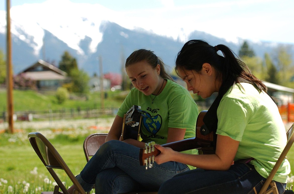 &lt;p&gt;Tori Peterson, left, and Shaniya Decker warm up their voices and fingers before the Earth Day event on Sunday afternoon. The girls prepared three songs to play for the event, Hallelujah, Home, and Colors of the Wind.&lt;/p&gt;