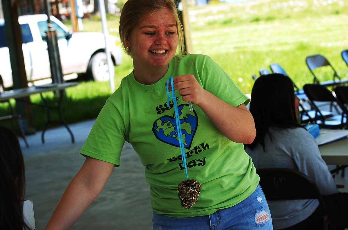 &lt;p&gt;Kassidy Dougherty holds up her finished pinecone birdfeeder. The feeders were first covered in peanut butter then layered with bird seed, making a tasty snack for any bird.&lt;/p&gt;