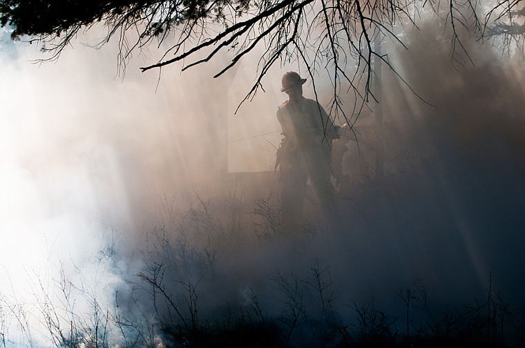 &lt;p&gt;A firefighter sprays water while fighting a fire Thursday afternoon west of Kila. The fire approached a home but caused no damage to the structure. No one was injured in the fire. May 1, 2014 in Kila, Montana. (Patrick Cote/Daily Inter Lake)&lt;/p&gt;