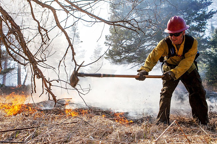 &lt;p&gt;A Montana Department of Natural Resources firefighter digs a line while fighting a fire Thursday afternoon west of Kila. The fire approached a home but caused no damage to the structure.&lt;/p&gt;