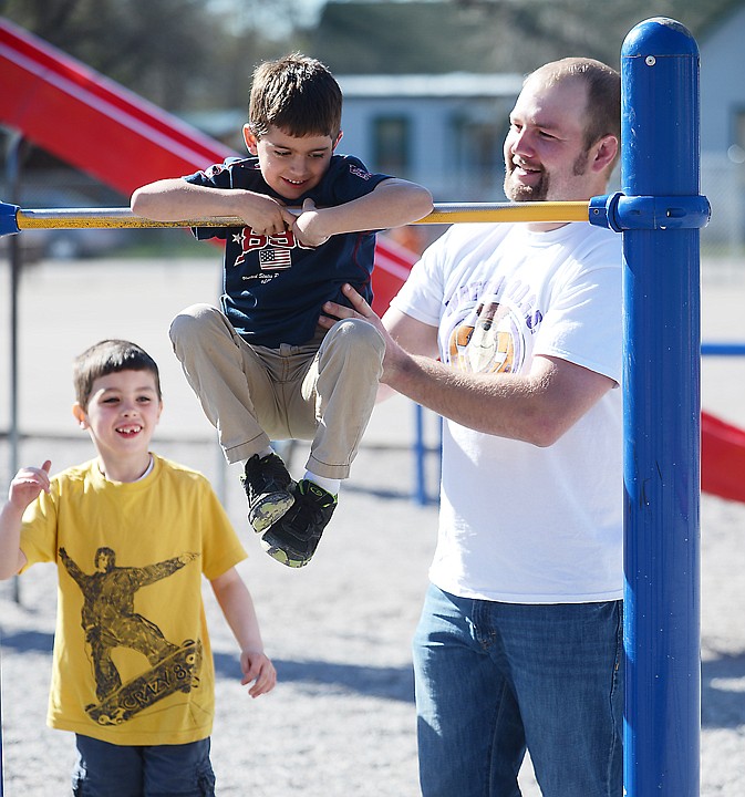 &lt;p&gt;Keevin Bertelsen, part of the Watch DOGS, program helps Miles Sands, center, and Dawson Duncan, at Elrod Elementary on Thursday, May 1, in Kalispell. (Brenda Ahearn/Daily Inter Lake)&lt;/p&gt;