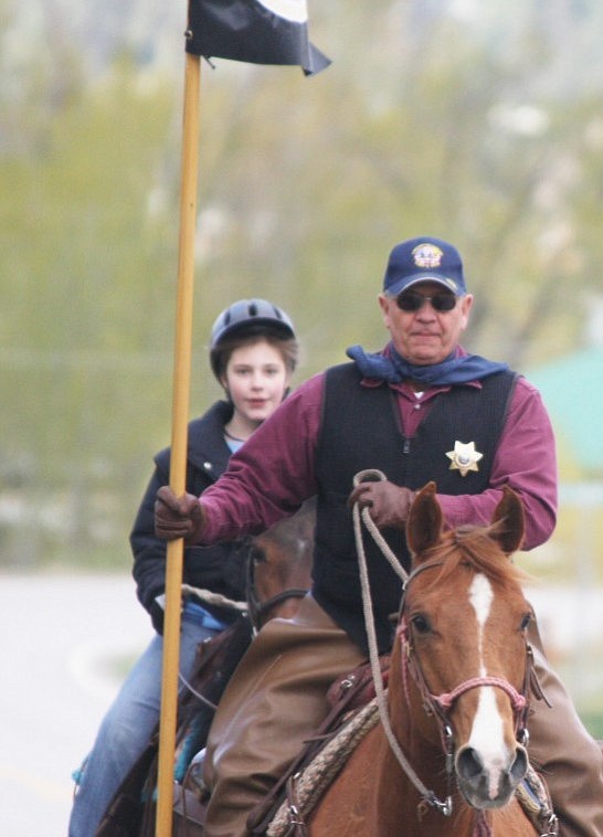 Sheriff Gene Arnold followed by Taylor Spring lead the Pony Express down Hwy. 28.