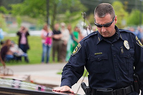 &lt;p&gt;Coeur d&#146;Alene Police Chief Lee White lays his hand on a stone memorial marker after placing his mourning band top. Sgt. Greg Moore&#146;s name is the most recent named to carved into the face of the marker after being killed in the line of duty last week in Coeur d&#146;Alene. (Published May 16, 2015)&lt;/p&gt;