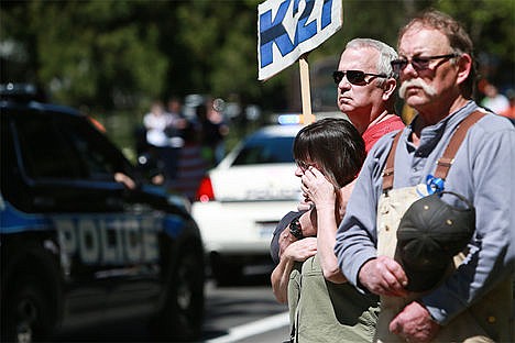 &lt;p&gt;Sally and Steven Hicks hold a K27 sign during the funeral procession for Sgt. Greg Moore outside of Forest Cemetery on Government Way on Saturday, May 9, 2015.&lt;/p&gt;