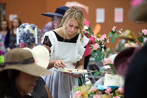 &lt;p&gt;Tayler Coats serves tea sandwiches at the Mad Hatter&#146;s Tea Party at the Lake City Center Saturday.&lt;/p&gt;