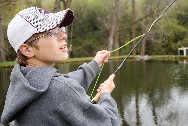 Warren Wood, a sixth grader from Plains, eyes his false casting technique at a private pond near Plains.