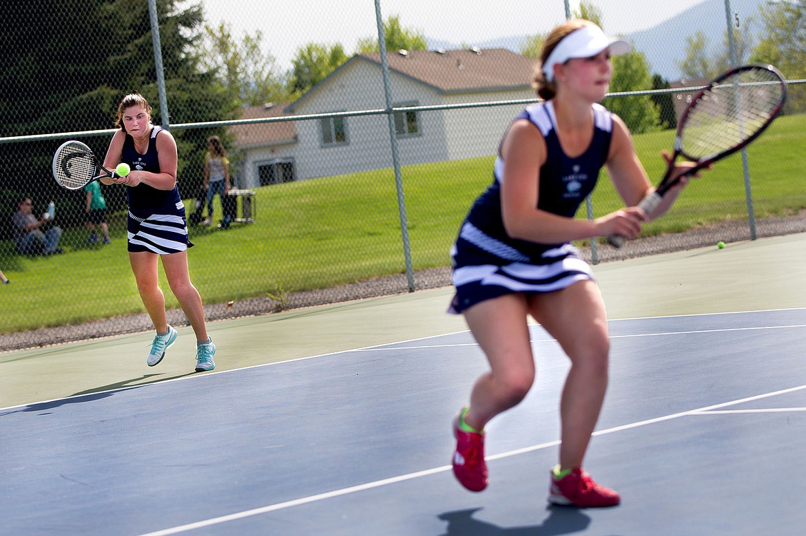 &lt;p&gt;JAKE PARRISH/Press Lake City's Madison Morris returns a serve as doubles teammate Bryce Martin watches Coeur d'Alene's Lauren Carlsen and Sarah Swider on Wednesday at Lake City High School.&lt;/p&gt;