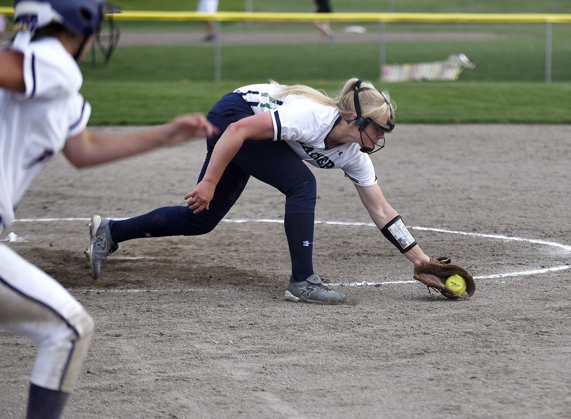 &lt;p&gt;Glacier pitcher Ali William lunges to pick up a ground ball during the Wolfpack's 8-5 victory over Polson at Kidsports on Thursday. (Aaric Bryan/Daily Inter Lake)&lt;/p&gt;