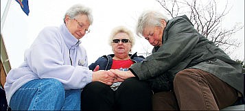 &lt;p&gt;From left, Joan Kirsebom, Mary Anny Ryan and Tommie Ernist, all of Post Falls, pray during the National Day of Prayer at the Post Falls City Hall plaza on Thursday.&lt;/p&gt;