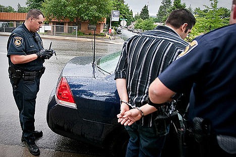 &lt;p&gt;In this June, 17, 2009 Press file photo, Coeur d'Alene Police officer Greg Moore takes inventory of a wanted person's possessions after he was arrested at the Department of Motor Vehicles. Moore was shot after responding to a call of a suspicious male in the Sunshine Meadows neighborhood in the early morning hours Tuesday.&lt;/p&gt;