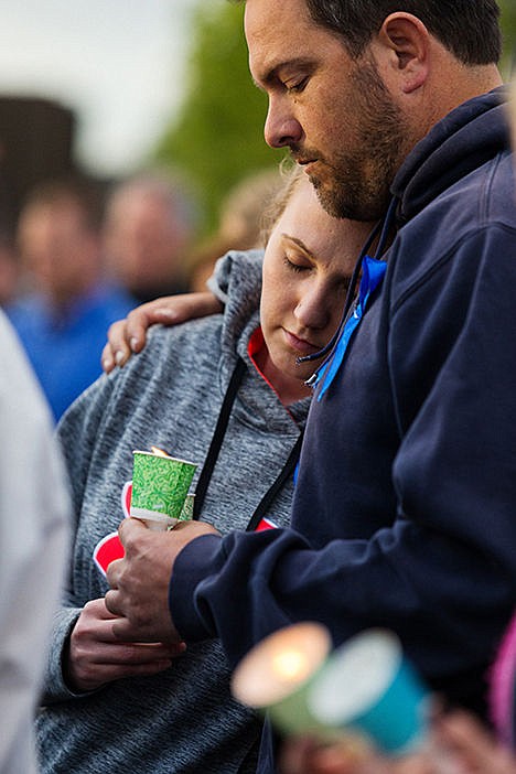 &lt;p&gt;Jason Charter holds his wife Mikhaela during one of many group prayers for Sgt. Moore and his family. (Published May 6, 2015)&lt;/p&gt;