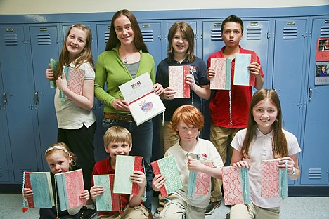 &lt;p&gt;Students at Sorensen Magnet School for the Arts and Humanities pose with copies of &#147;Spike &#133; One Dragon&#146;s Tale,&#148; a book they wrote, illustrated and hand-bound and will sell to raise money to drill a water well in a remote Ethiopian MAUREEN DOLAN/Press Students at Sorensen Magnet School for the Arts and Humanities pose with copies of &#147;Spike &#133; One Dragon&#146;s Tale,&#148; a book they wrote, illustrated and hand-bound and will sell to raise money to drill a water well in a remote Ethiopian village. Front row from left are Lydia Howard, Tate Erwin, Mickey Howard and Melia Hannigan-Luther. Back row from left are Libby Goodwin, Sharalee Howard, Aubrey Payne and Jack Barrett.&lt;/p&gt;