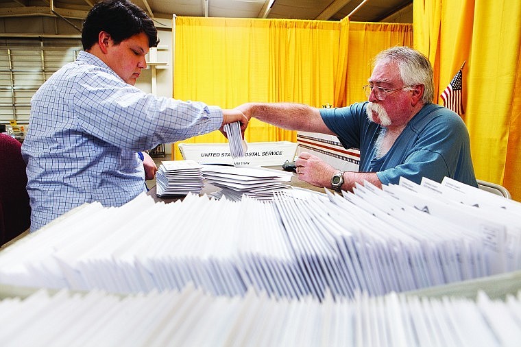 &lt;p&gt;Tony Brockman, left, and Clifford Lee sort through envelopes they stuffed with absentee ballots Friday afternoon at the temporary elections office in the Country Fair Kitchen at the Flathead County Fairgrounds. &quot;It's been an all week process,&quot; Brockman said. Flathead County is mailing out 11,500 absentee ballots as early voting begins today.&lt;/p&gt;