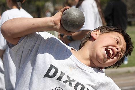 Photo by Aaric Bryan Dixon seventh-grader Anthony Johnson grunts as he throws the shot put 16 feet, 3 inches at the Sanders County Junior High Track Meet Friday at Thompson Falls.