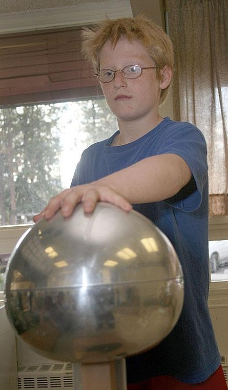 Photo by Nick Ianniello Superior student River Sides shows off the school's Van de Graaff Generator and his new electrifying hairdo. The Van de Graaff Generator sends a current of electricity through the user's arm.