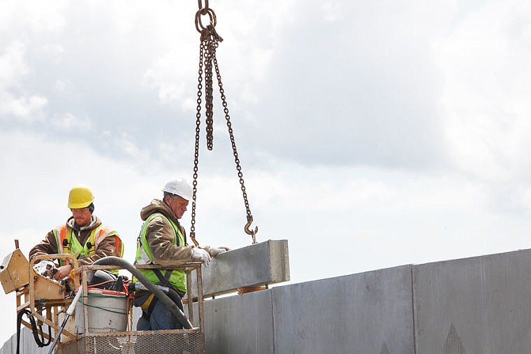 &lt;p&gt;Jimmy Roth, left, and Roy Truman of Glacier Precast Concrete install an extension on the sound wall near the U.S. 93 Alternate Route west of Kalispell on Wednesday afternoon. Traffic may be affected when installation of the large extensions continues next week. May 1, 2013 in Kalispell, Montana. (Patrick Cote/Daily Inter Lake)&lt;/p&gt;