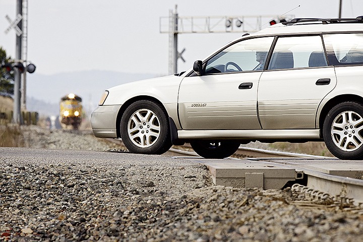 &lt;p&gt;JEROME A. POLLOS/Press A motorist drives across the train tracks on Idaho Street near Prairie Avenue in Post Falls as a train approaches the crossing Friday. Law enforcement agencies took part in an &quot;Officer on a Train&quot; enforcement effort where if a motorist is observed violating laws pertaining to approaching a rail intersection, an officer will stop the motorist, explain the dangers and issue a citation, if warranted.&#160;&lt;/p&gt;