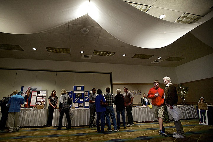 &lt;p&gt;JEROME A. POLLOS/Press Brian Carlstad and his son Ben, 14, scan the room of the 6th annual Kootenai County Young Professionals Volunteer Fair held Wednesday at the Coeur d'Alene Best Western Inn. More than 50 local non-profit organizations were at the event to discuss volunteering opportunities, events and fundraising.&lt;/p&gt;