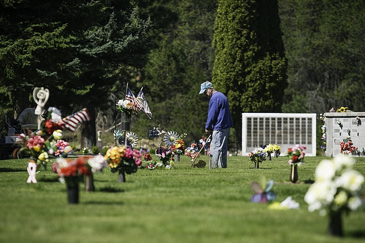 &lt;p&gt;SHAWN GUST/Press Larry House, groundskeeper at Coeur d'Alene Memorial Gardens, uses a trimmer to landscape the area around head stones Friday during his shift.&lt;/p&gt;