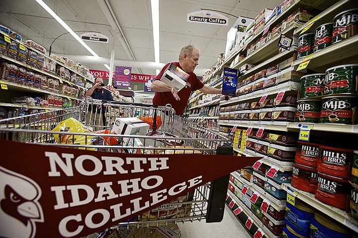 &lt;p&gt;JEROME A. POLLOS/Press Roger Stewart throws boxes of coffee into his shopping cart during his two-minute North Idaho College Cardinal shopping spree Thursday through Super 1 Foods in Coeur d'Alene. Stewart won a drawing at NIC which raised money for the college's athletics department. During his spree, Stewart was able to accumulate $670 worth of groceries with a large portion of bulk items which he'll donate to his church's soup kitchen.&lt;/p&gt;