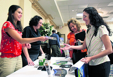 &lt;p&gt;Nicole Cepeda, left, and Shawna Beleckis, second from left, of Hilton Hotels, pass out information about possible employment positions to Lily Rios, second from right, and Sheila Guevara at a job expo sponsored by Direct USA in Orlando, Fla.&lt;/p&gt;