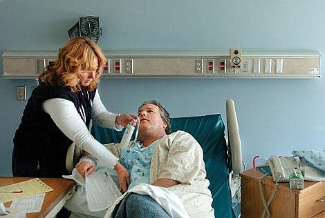 Nurse Louise Montalvo attends to Gary Cockerill at Kalispell Regional Medical Center before Cockerill was released on Friday. Cockerill suffered a heart attack at Grouse Mountain Lodge on Tuesday and was saved by Crissy Weibert, who used an automatic external defibrillator to revive him. Chris Jordan/Daily Inter Lake