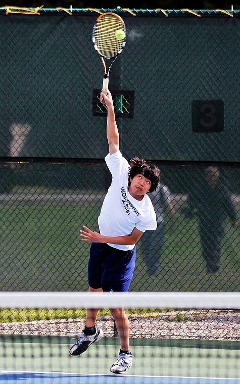 Glacier&#146;s Patrick Phattharaampornchai connects on a serve against Flathead&#146;s Cole Francisco during Thursday&#146;s crosstown dual at the FVCC courts. Phattharaampornchai won in two sets, 6-1, 6-3.