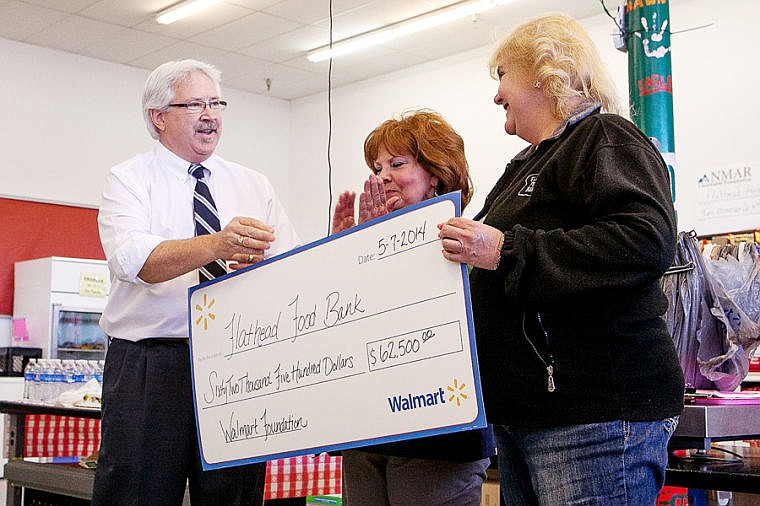 &lt;p&gt;Flathead Food Bank executive director Lori Botkin, right, accepts a donation from Walmart general manager Lance Lerud, left, Wednesday morning at the food bank in Kalispell. The $62,500 donation was part of the Walmart Foundation's State Giving Program, a quarterly grant given to non-profit organizations. The Flathead Food Bank's grant was written by Catherine Webber, center. May 7, 2014 in Kalispell, Montana.&lt;/p&gt;