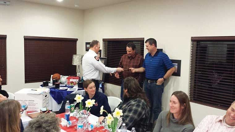 Kyle Gilbert and Tony Freeman receive their recognition as Firefighters of the year for Grant County Fire District No. 11.