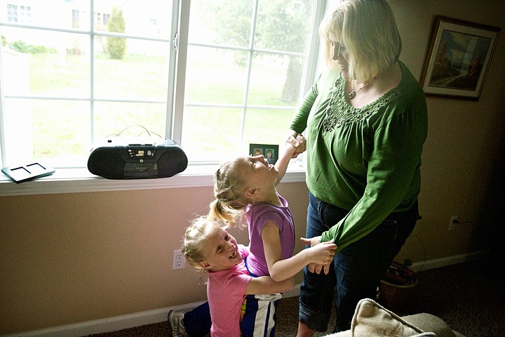 &lt;p&gt;Cindy Barnett plays with her daughters Josie, center, and Mariah, both 7, Friday at their home in Post Falls.&lt;/p&gt;