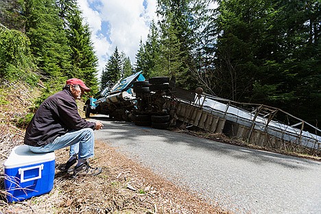 &lt;p&gt;Demetrio Rayo, owner of Rayo Trucking, sits on a cooler Wednesday while waiting for a tow service at the site where his truck slid off the road Wednesday in the Beauty Creek area.&lt;/p&gt;