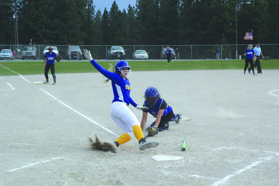 &lt;p&gt;Lady Hawks Freshman Lexi Van Elswyk avoids the tag from the Mission-Arlee-Charlo catcher during a game last Friday.&lt;/p&gt;