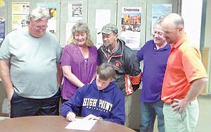 <p>Christian Langston of Lincoln County High School signs his Letter of Commitment to High Point University as Coach Rick Bean, Mom, Stormy Langston, Coach Joe Lewecki, Dad, Terry Langston and Coach and Athletic Director Chad Dunn look on.</p>