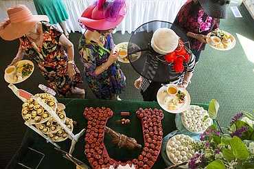 <p>LOREN BENOIT/Press Donning their Kentucky Derby hats, Blazen Divaz fill their colorful lunch plates with dessert before watching the race on Saturday at the Hayden Lake Country Club.</p>