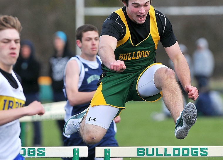 Whitefish's Ryan Zalucky clears a hurdle while running the 300m Hurdles.