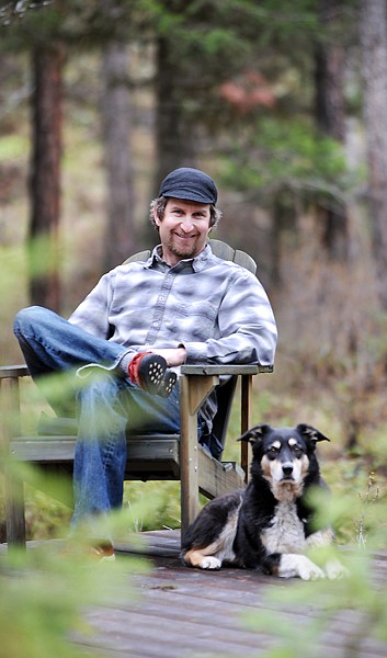 Pete Thomas and his dog on Thursday near his home in rural Whitefish.