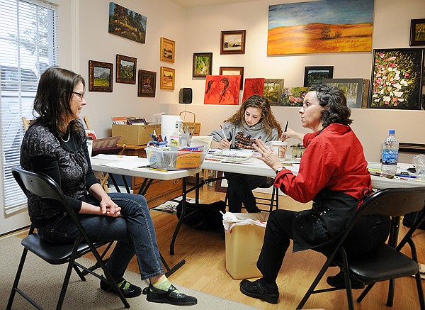 Deborah Schultz of Kalispell, left to right, and her daughter Hannah take the Wild and Wicked Watercolors on Yupo Paper with Whitefish artist Jane Latus Emmert in her studio on Tuesday.