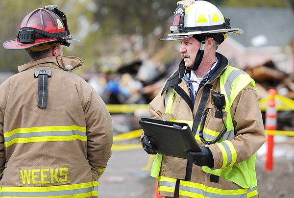 Columbia Falls Fire Chief Rick Hagen, right, at the scene of Thursday's explosion near 2nd Avenue West and 12th Street in Columbia Falls.