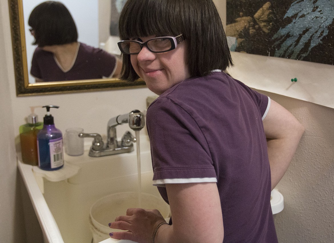 &lt;p&gt;Stacy Tritto fills the dogs&#146; water bucket as part of her chores.&lt;/p&gt;