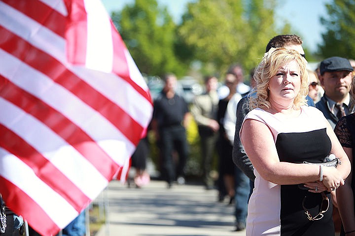 &lt;p&gt;Debbie Haug of Post Falls looks to the distant line filtering into Lake City High School for the funeral of Sgt. Greg Moore on Saturday.&lt;/p&gt;