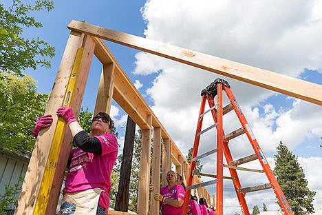 &lt;p&gt;Shelly Donovan, executive officer with the North Idaho Building Contractors Association, uses a level as a group of volunteers secure a wall Wednesday during the construction of a home in Post Falls during Women Build Week for Habitat for Humanity.&lt;/p&gt;