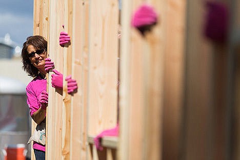 &lt;p&gt;Lea Williams, a real estate agent with Tomlinson Sotheby&#146;s, peeks out from between wall studs after raising a framed outside wall. Williams has been a volunteer with the Habitat for Humanity&#146;s Women Build Week for about five years.&lt;/p&gt;