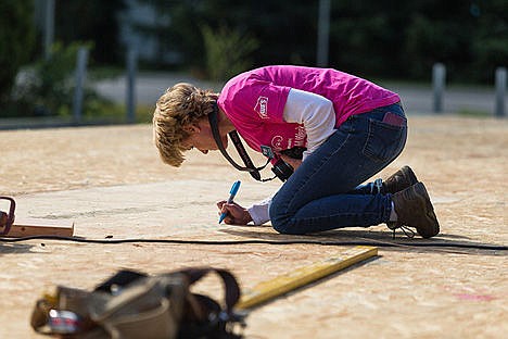 &lt;p&gt;Katrina Boyer, volunteer coordinator for Habitat for Humanity, writes a message reading &#147;May all your dreams become your memories here&#148; on the sub-floor of the Post Falls construction project.&lt;/p&gt;