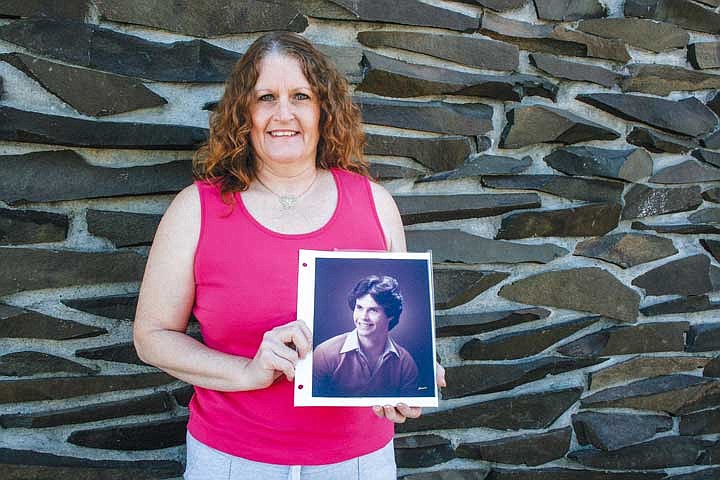 Nancy Thorne of Moses Lake with her brother Mark Timm's graduation picture. Thorne's said joining a support group, like the one starting in Moses Lake next week, helped her come to terms with her brother's suicide.