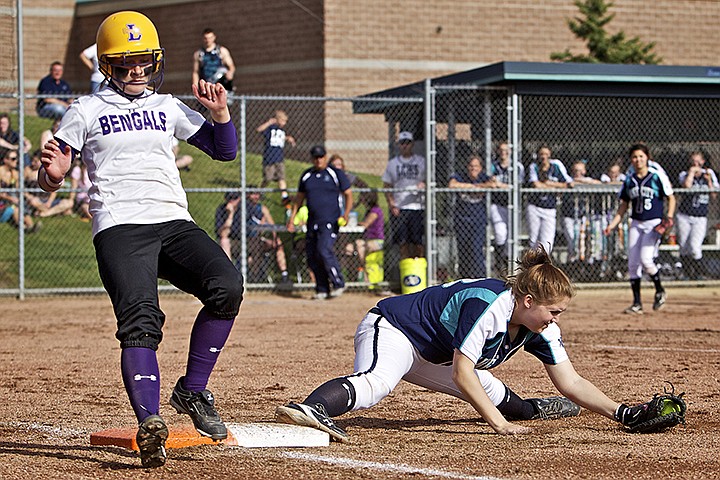 &lt;p&gt;JEROME A. POLLOS/Press Lake City High's Kory Kritz makes the stretch to reach the ball for an out on Kellsi Parson from Lewiston High to closing the inning Tuesday in the 5A Region 1 tournament championship game.&lt;/p&gt;