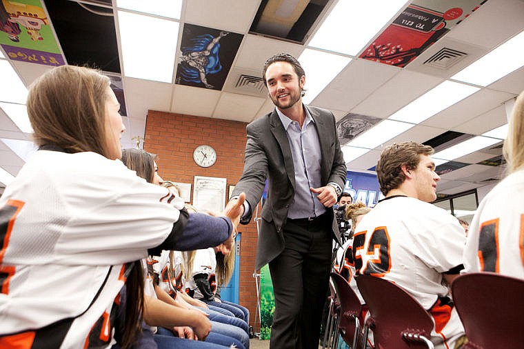 &lt;p&gt;Denver Broncos quarterback and former Flathead High School student Brock Osweiler, right, celebrates with his team of students after they converted a first down in a game of &#147;Financial Football,&#148; a video game to promote financial literacy. The event was Friday morning at Flathead High School.&lt;/p&gt;