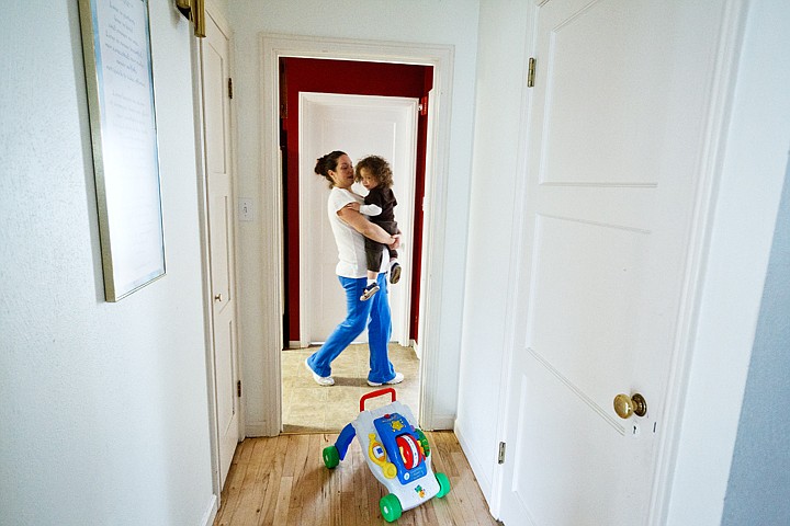 &lt;p&gt;Elizabeth Gonzalez carries her one-year-old son Yomar Lopez through a hallway in the Mary House on Monday. Gonzalez, the house manager, came to St. Vincent de Paul's home for women earlier this year.&lt;/p&gt;