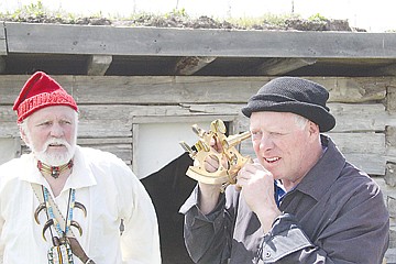 &lt;p&gt;Bruce Hunn peers through a sextant while receiving tips from reenactor Ted Hoglund, left.&lt;/p&gt;